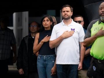 Republican vice presidential nominee, U.S. Sen. J.D. Vance (R-OH) and his wife Usha Vance (L) stand for the national anthem during a campaign stop...on September 14, 2024 in Greenville, North Carolina