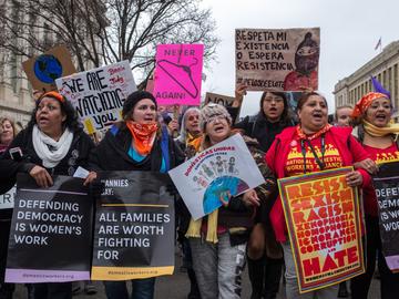 Protestors march as part of the Women's March which nationwide campaigned for legislation and policies regarding human rights, women's rights, immigration reform, healthcare reform, the natural enviro