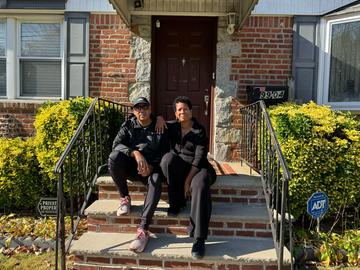 David Robinson and Teresa Kamara on the stoop of the home where they grew up in Hollis. Inside is a man they say is squatting in their family home.