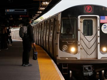 People wait to board an F-line train at the Smith Street - 9th Street subway station on May 7, 2025, in New York City.