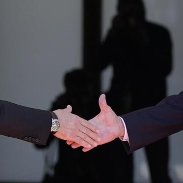 President Joe Biden, right, shakes hands and meets with Russian President Vladimir Putin