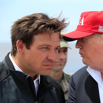 President Donald Trump talks to Florida Gov. Ron DeSantis, left, during a visit to Lake Okeechobee and Herbert Hoover Dike at Canal Point, Fla., Friday, March 29, 2019.