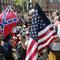 White nationalist demonstrators walk into Lee park surrounded by counter demonstrators in Charlottesville, Va., Saturday, Aug. 12, 2017.