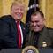 President Donald Trump welcomes Customs and Border Patrol agent Adrian Anzaldua, right, on stage to speak during an event to salute U.S. Immigration and Customs Enforcement (ICE) officers 