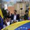 Juan Guaido, head of Venezuela's opposition-run congress, holds up an image of Venezuelan independence hero Simon Bolivar as he declares himself interim president.