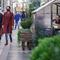 Two people wearing masks past by a shelter where diners are eating as part of outdoor dining at a restaurant in Manhattan. 