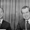 President Richard Nixon and South Vietnam President Nguyen Van Thieu sit at a table, smiling.