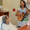 Danielle DeCosmo, an artist in residence at Shands, plays for a patient.