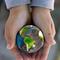 Hands holding globe