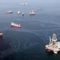 JULY 18: Oil sheen is seen with vessels assisting near the source of the BP Deepwater Horizon oil spill on July 18, 2010 in the Gulf of Mexico off the coast of Louisiana. 