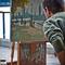 man painting on easel
