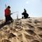 Residents plant beach grass on protective sand dunes in the Breezy Point neighborhood on the one-year anniversary of Hurricane Sandy on October 29, 2013 in the Queens borough of New York City.