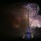 Bastille Day fireworks explode over the Seine river next to the Eiffel Tower in Paris Monday night, July 14, 2014. 