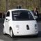 Google's Chris Urmson (R) shows a Google self-driving car to U.S. Transportation Secretary Anthony Foxx (L) and Google Chairman Eric Schmidt (C) at the Google headquarters on February 2, 2015.