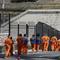 In this Aug. 16, 2016 photo, a row of general population inmates walk in a line at San Quentin State Prison in San Quentin, Calif. 