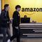 Employees walk through a lobby at Amazon's headquarters Tuesday, Nov. 13, 2018, in Seattle. 