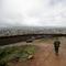 Border Patrol agent Vincent Pirro looks on near a border wall that separates the cities of Tijuana, Mexico, and San Diego, Tuesday, Feb. 5, 2019, in San Diego. 