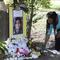 In this July 21, 2015 photo, Jeanette Williams places a bouquet of roses at a memorial for Sandra Bland near Prairie View A&M University, in Prairie View, Texas. 