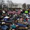 Demonstrators participate in a 'lie-in' during a protest in favor of gun control reform in front of the White House, Monday, Feb. 19, 2018, in Washington.