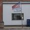 A slightly tattered flag flies outside the Nichols post office Saturday, Jan. 25, 2020, in Nichols, Iowa. 