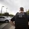 In this July 8, 2019, file photo, a U.S. Immigration and Customs Enforcement (ICE) officer looks on during an operation in Escondido, Calif. 