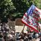 A protester waves an American flag with a message that reads 'CAN'T BREATHE' during a memorial for George Floyd at Cadman Plaza Park in the Brooklyn borough of New York, on Thursday, June 4, 2020. 