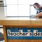 Des Moines Public Schools custodian Joel Cruz cleans a teacher's desk in a classroom at Brubaker Elementary School, Wednesday, July 8, 2020, in Des Moines, Iowa.