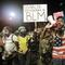 A demonstrator shouts slogans using a bullhorn next to a group of military veterans during a Black Lives Matter protest at the Mark O. Hatfield United States Courthouse July 26, 2020, in Portland, OR.