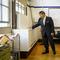 School Chancellor Richard Carranza, left, feels for airflow from a ventilation unit inside a classroom at Bronx Collaborative High School, during a visit with Mayor Bill de Blasio, right, to review he
