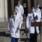 Dr. Sean Conley, physician to President Donald Trump, center, and other doctors, walk to talk with reporters at Walter Reed National Military Medical Center, Monday, Oct. 5, 2020, in Bethesda, Md. 