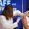 U.S. Surgeon General Jerome Adams receives a Pfizer-BioNTech COVID-19 vaccine shot at the Eisenhower Executive Office Building on the White House complex, Friday, Dec. 18, 2020, in Washington.
