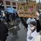 A demonstrator holds up a sign while marching during a protest Wednesday, April 21, 2021 in the Nubian Square neighborhood of Boston, a day after a guilty verdict was announced at the trial of former 