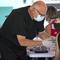 A person getting a Johnson & Johnson vaccine by a health care worker at the one-time pop-up vaccination site located 16th Street beach on the sand on Sunday, May 2, 2021 in Miami Beach.