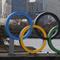 A worker is dwarfed by the Olympics Rings on a barge Friday, Jan. 17, 2020, in the Odaiba district of Tokyo.