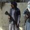 Taliban fighters stand guard in the main gate leading to Afghan presidential palace, in Kabul, Afghanistan, Monday, Aug. 16, 2021. The U.S. military struggled to manage a chaotic evacuation.