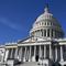 looking up at the u.s. capitol building on a cloudless day