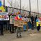 Protestors hold signs regarding Ukraine as they stand outside the security perimeter during a meeting of NATO defense ministers at NATO headquarters in Brussels, Wednesday, March 16, 2022. 