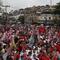 A large doll in the likeness of Brazil's former President Luiz Inacio Lula da Silva, who is running for office again, is paraded through the Complexo do Alemao favela at his campaign rally