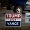 Signs showing support for both Democratic presidential candidate Vice President Kamala Harris and Republican presidential candidate former President Donald Trump sit along a rural highway on September