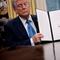 U.S. President Donald Trump hold up an executive order, 'Unleashing prosperity through deregulation,' that he signed in the Oval Office on January 31, 2025 in Washington, DC.
