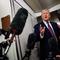 U.S. President Donald Trump takes questions from the members of the press aboard Air Force One on January 11, 2026 en route back to the White House from Palm Beach, Florida.