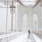 People walk along the Brooklyn Bridge as snow falls during a blizzard on February 23, 2026 in New York City.