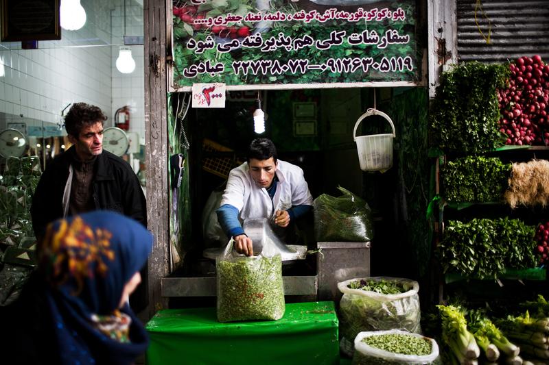 An Iranian man prepares some chopped mixed vegetables for Iranian dish recipes at Tajrish bazaar in northern Tehran on January 24, 2015.