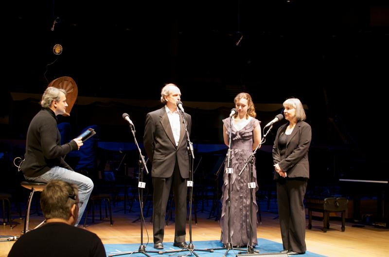 Violinist Emily Switzer and her parents on stage