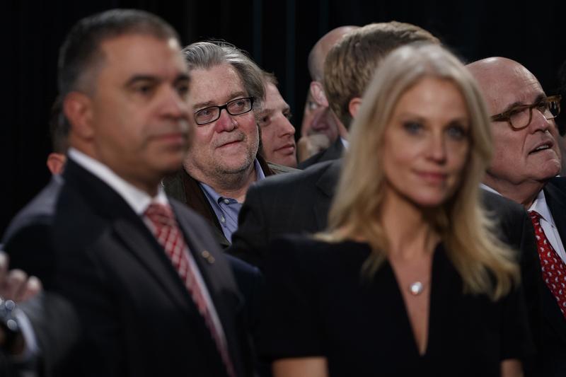 Steve Bannon, center left, back, stands among Trump cabinet hopeful, Rudy Giuliani, right, back.