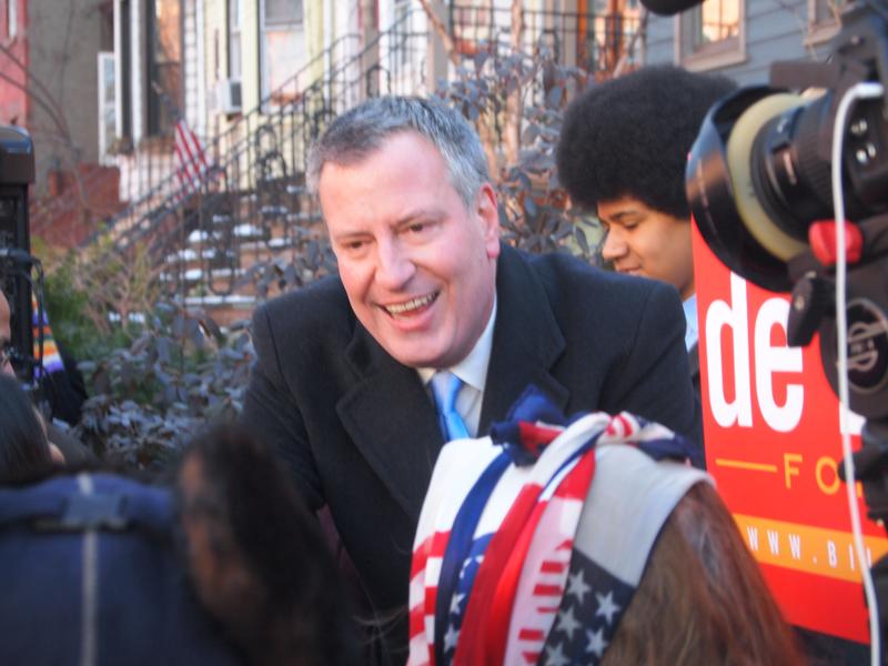 Bill De Blasio reaches out to supporters as his son Dante stands nearby