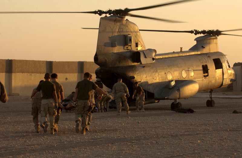 Medical personnel from Forward Operating Base Hotel rush critically injured Iraqi Police officers to an awaiting CH-46 Sea Knight helicopter in 2004.