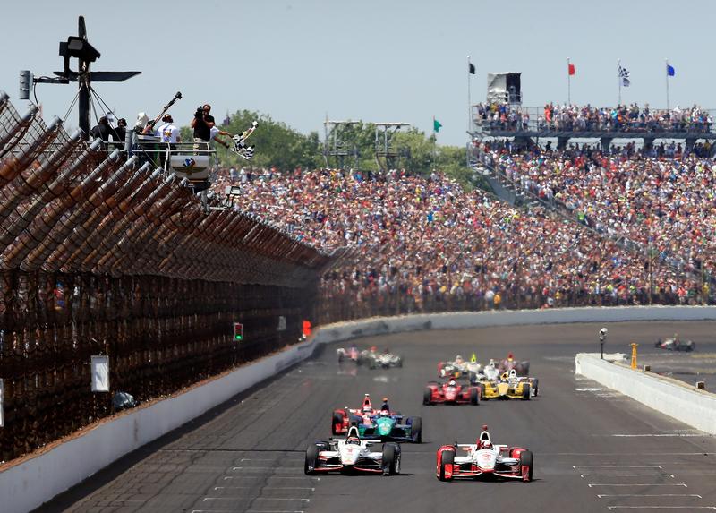 Juan Pablo Montoya of Columbia, driver of the #2 Team Penske Chevrolet Dallara, celebrates after crossing the finish line to win the 99th running of the Indianapolis 500 at Indianapolis Motorspeedway.