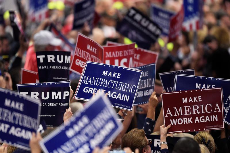 At day two of the Republican National Convention, supporters wave signs about the economy