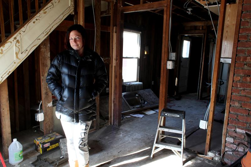 Jennifer Avena stands in her home at  Gerritsen Beach, Brooklyn,which took on five feet of water during Hurricane Sandy.